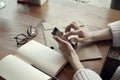 Close-up view of woman hands with hipster envelops cafe