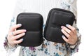 Close up view of woman hands holding two black cases for drone Royalty Free Stock Photo