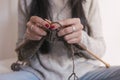 close up view of woman hands knitting on bed. Working at Home, indoors Royalty Free Stock Photo