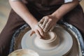 Close-up view of woman hands working on pottery wheel and making clay pot. Hands sculpts a cup from clay pot. Workshop Royalty Free Stock Photo