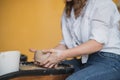 Close-up view of woman hands working on pottery wheel and making clay pot. Hands sculpts a cup from clay pot. Workshop Royalty Free Stock Photo