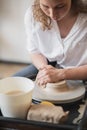 Close-up view of woman hands working on pottery wheel and making clay pot. Hands sculpts a cup from clay pot. Workshop Royalty Free Stock Photo