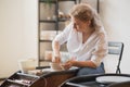 Close-up view of woman hands working on pottery wheel and making clay pot. Hands sculpts a cup from clay pot. Workshop Royalty Free Stock Photo