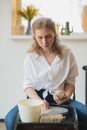 Close-up view of woman hands working on pottery wheel and making clay pot. Hands sculpts a cup from clay pot. Workshop Royalty Free Stock Photo