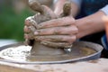 Close-up view of woman hands working on pottery wheel and making clay pot. Workshop on modeling on the potter`s wheel. Young woman Royalty Free Stock Photo