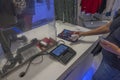 Close up view of woman holding check in her hand for purchase at cash register at Macy`s. New York.