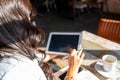 Woman holding a digital tablet with empty black screen while working sitting in a coffee shop Royalty Free Stock Photo