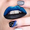 Close up view of woman lips with sparkly blue black lipstick open mouth. Cosmetology fashion makeup beautiful manicure