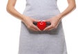 Close up view of woman with red heart on white background. Gynecology concept Royalty Free Stock Photo