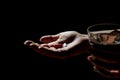 Close-up view of woman`s or girl`s hand holding medication pills, tablets and glass of water. Night photo with high contrast, Royalty Free Stock Photo