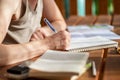 Close-up view of a woman`s hand with a pen, writes in a notebook Royalty Free Stock Photo