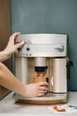 Close-up view of woman`s hands brewing a cup of coffee Royalty Free Stock Photo