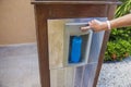 Close up view of woman's hands filling plastic bottle with ice cubes drinking water from generator. Aruba. Royalty Free Stock Photo