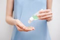 Close up view of woman`s hands using a personal antiseptic or sanitizer. Covid-19 protection measures