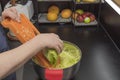 Close up view of woman shredding cabbage.