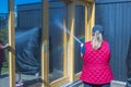 Close up view of woman spooling windows with water before washing them.