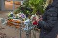 Close up view of woman in store with shopping trolley inspects purchased gardening supplies.