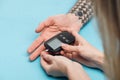 Close up view of woman testing man blood sugar level with glucometer Royalty Free Stock Photo