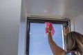 Close-up view of woman washing dormer window in villa.