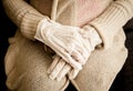 Close up view of woman wearing white moisturizing spa hand mask gloves. Royalty Free Stock Photo
