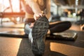 Close up view of woman& x27;s hands touching her toes from sitting position, as a stretching exercise for flexibility at Royalty Free Stock Photo