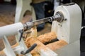 Close up view: wood turning lathe machine with shavings at workshop Royalty Free Stock Photo