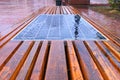 Close-up view of wooden bench with integrated solar panel for charging gadgets on the street. Concept of smart city in Kyiv Royalty Free Stock Photo