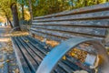 Close up view of wooden bench with metal on city street in the park Royalty Free Stock Photo