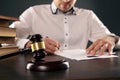 Close up view of wooden gavel. Male attorney working with paper documents. Royalty Free Stock Photo