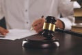 Close up view of wooden gavel. Male attorney working with paper documents. Royalty Free Stock Photo