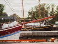 close up view on a wooden sailboat bow moored in a city harbor in sun backlit Royalty Free Stock Photo