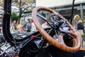 Close-up view of a wooden steering wheel on the old vintage vehicle