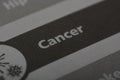 Close up view of the word CANCER. Cancer is a group of diseases characterized by the uncontrolled growth and spread of abnormal
