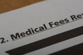 Close up view of the word MEDICAL FEES. Medical fees refer to the charges or fees that healthcare providers for their services, Royalty Free Stock Photo