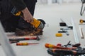 A close-up view of worker cutting metal with angle grinder at construction site Royalty Free Stock Photo
