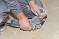 Close up view of a worker's hands prepared to use a radial saw.