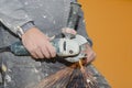 Close up view of a worker's hands using a radial saw.