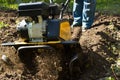A close up view on working motor cultivator