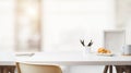 Close up view of workspace with copy space, frame, stationery, coffee cup and croissant on white table with blurred