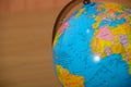 Close up view of world globe on wooden background