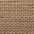 A close-up view of a woven jute fabric showcasing its natural, fibrous texture. The intertwining Royalty Free Stock Photo