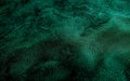 A close-up view of a wrinkled, textured emerald green leather surface, capturing the rich, luxurious feel and visual Royalty Free Stock Photo