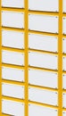 A close-up view of a yellow mailbox with multiple empty slots. The mailbox is organized and designed for postal services Royalty Free Stock Photo