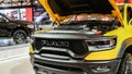 Close up view of yellow RAM truck car on display. Crowds looking at new car models at Auto show. National Canadian Auto Show with