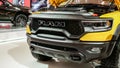 Close up view of yellow RAM truck car on display. Crowds looking at new car models at Auto show. National Canadian Auto Show with