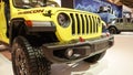 Close up view of yellow Rubicon Jeep car on display. Crowds looking at new car models at Auto show. National Canadian Auto Show