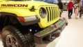 Close up view of yellow Rubicon Jeep car on display. Crowds looking at new car models at Auto show. National Canadian Auto Show