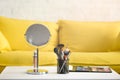 close up view of yellow sofa mirror makeup brushes and cosmetics on coffee Royalty Free Stock Photo