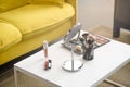 close up view of yellow sofa mirror makeup brushes and cosmetics on coffee Royalty Free Stock Photo