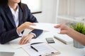 Close up view of Young Asian business woman receiving salary or bonus money from boss or manager at office happily Royalty Free Stock Photo